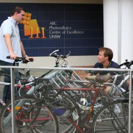 Students with bicycles near ARC Photovoltaics Centre of Excellence