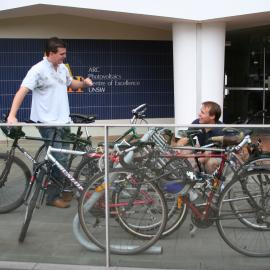 Students with bicycles near ARC Photovoltaics Centre of Excellence