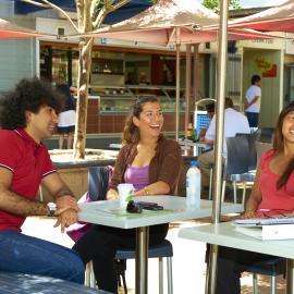 Students at Café Tables near Library Lawn