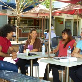 Students at Café Tables near Library Lawn