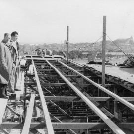 Workmen inspecting and clearing copper roofing 