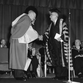 Mr Justice John Clancy congratulates Mr Frank Mathews 